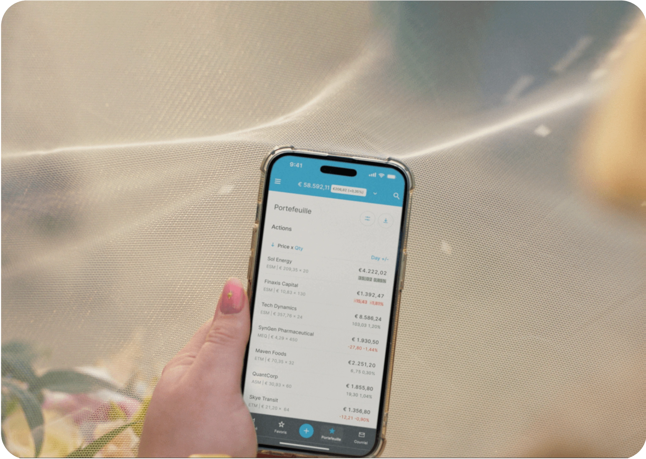 Hand holding smartphone displaying EXDEGIRO app portfolio screen with stocks and prices.
