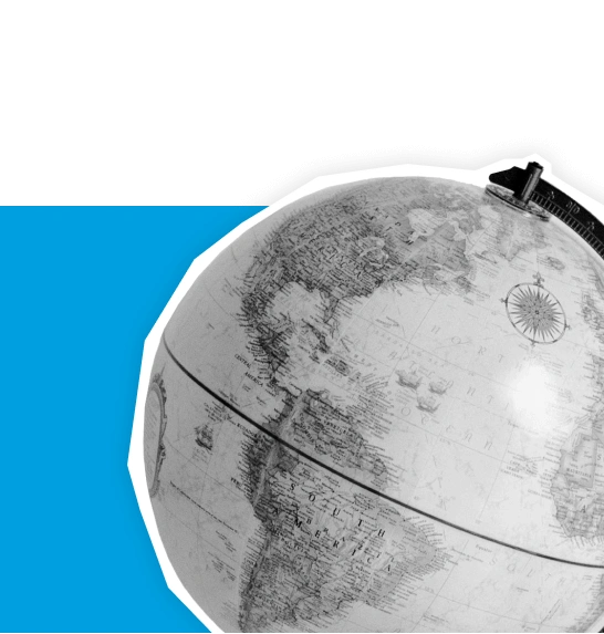 Close-up of desk globe showing world map with blue background shape